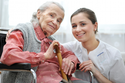 senior woman and her caregiver smiling