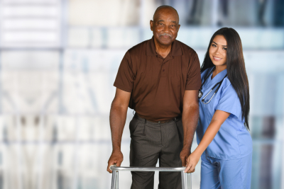 female caregiver assisting elder man on walking